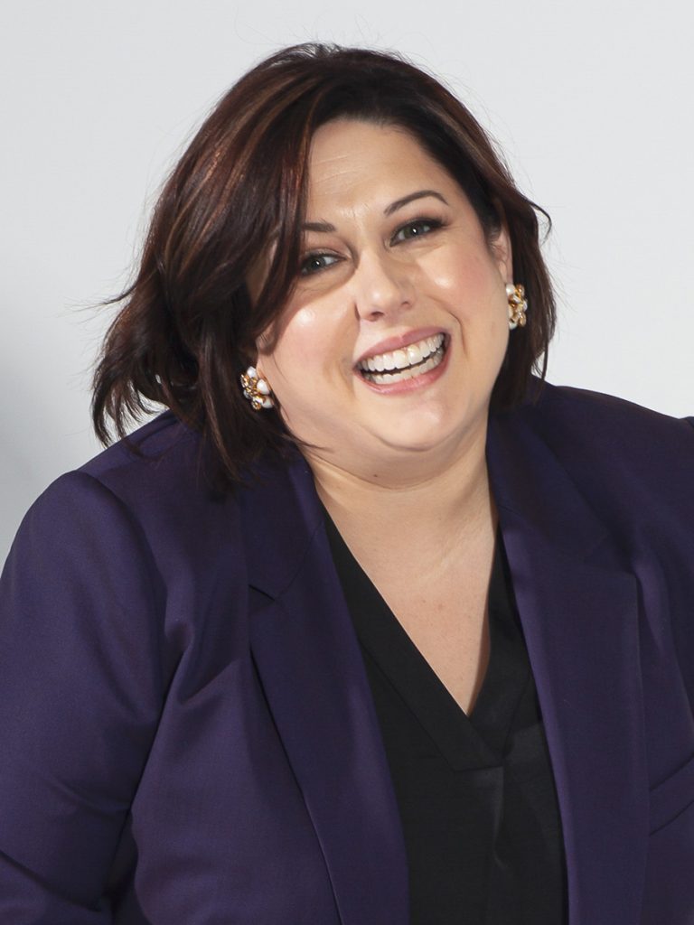 Headshot of Jessica Post smiling and wearing a blue blazer while looking directly at the camera.