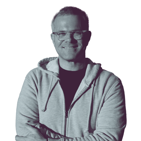 A black and white image of Ryan Hampton of Nevada Assembly district four from the waist up smiling and looking into the camera.