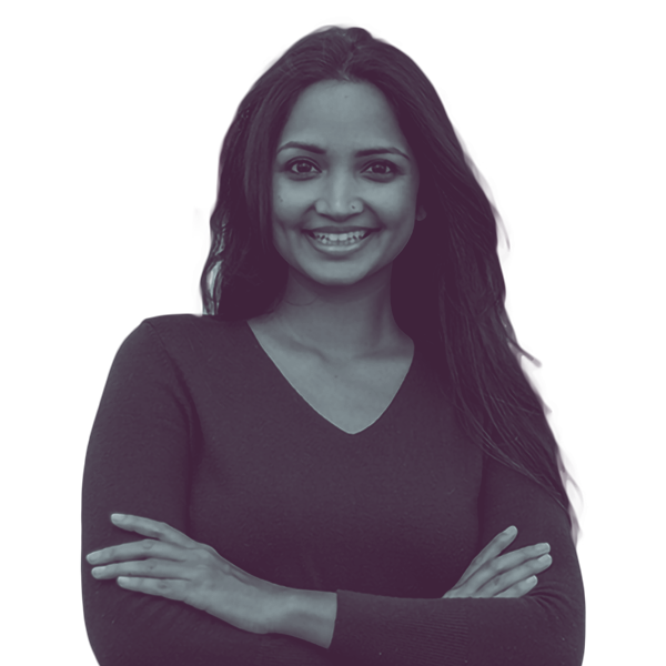 A black and white image of Nabilah Islam Parkes of Georgia Senate district seven from the waist up smiling and looking into the camera.