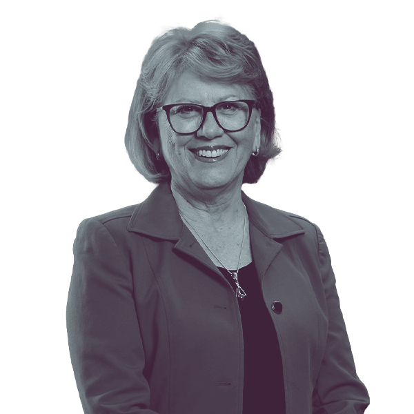 A black and white image of Judy Schwiebert of Arizona Senate district two from the waist up, smiling and looking into the camera.