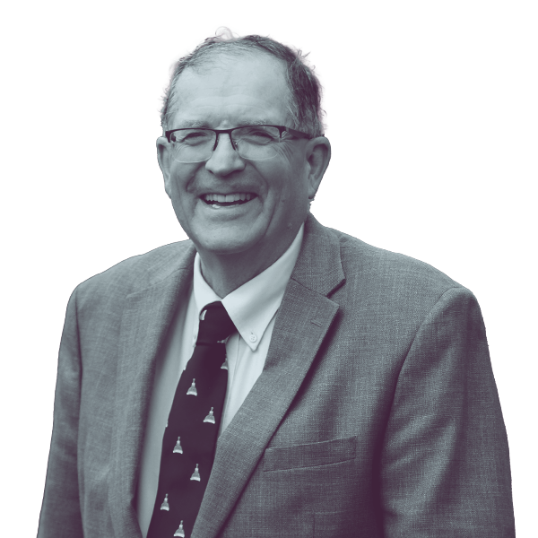 A black and white waist-up portrait of Mark Vallone, candidate for New Hampshire House District Rockingham five, smiling and looking into the camera.