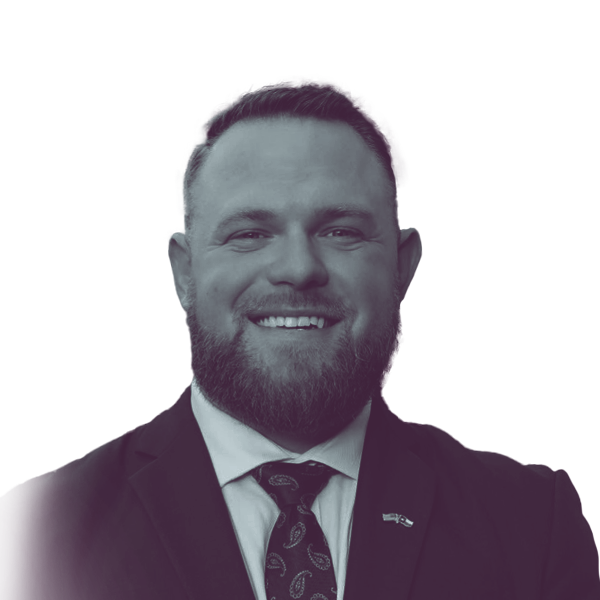 a black and white portrait of Taylor Rehmet, Democratic candidate for Texas Senate district 9, smiling and looking into the camera